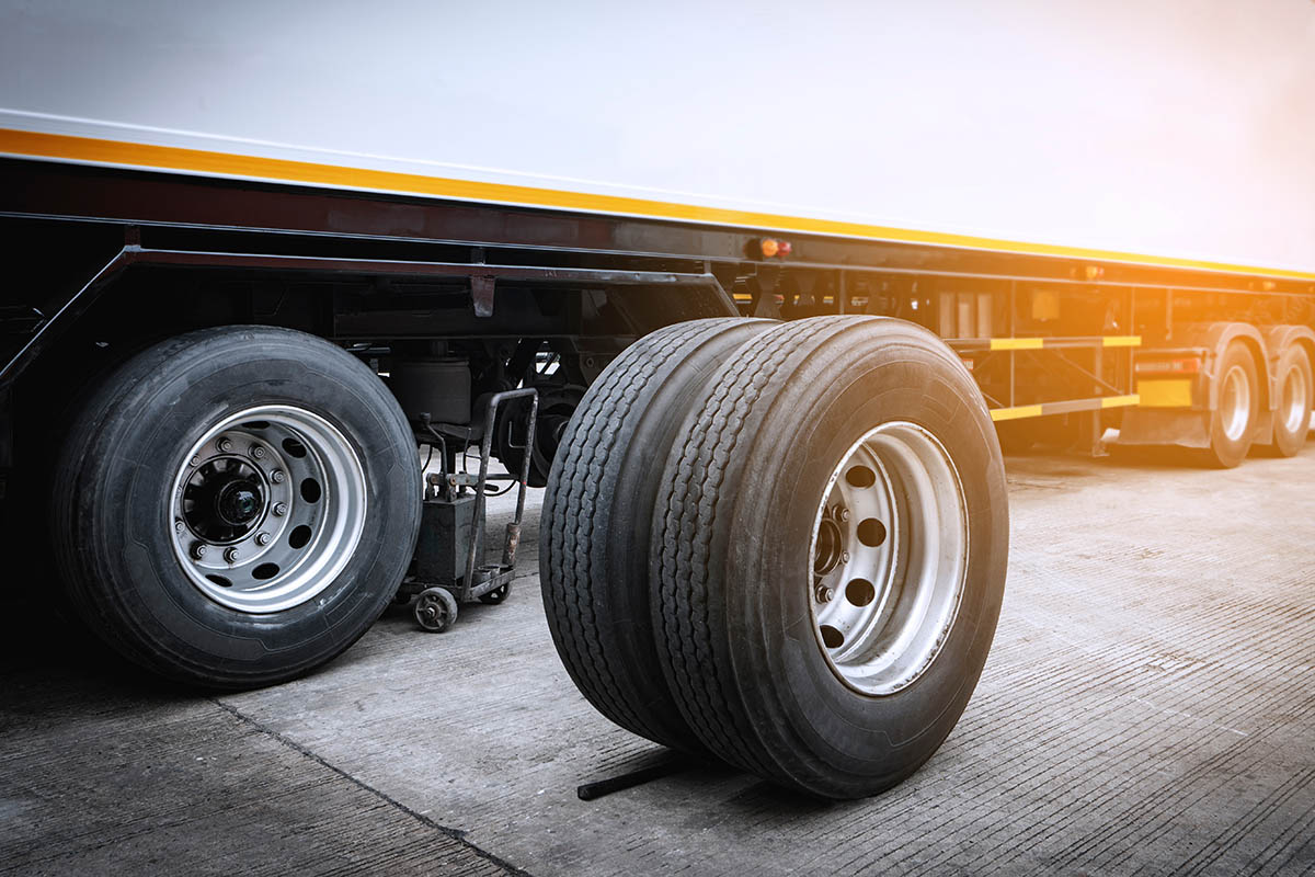 Commercial truck tires next to semi trailer