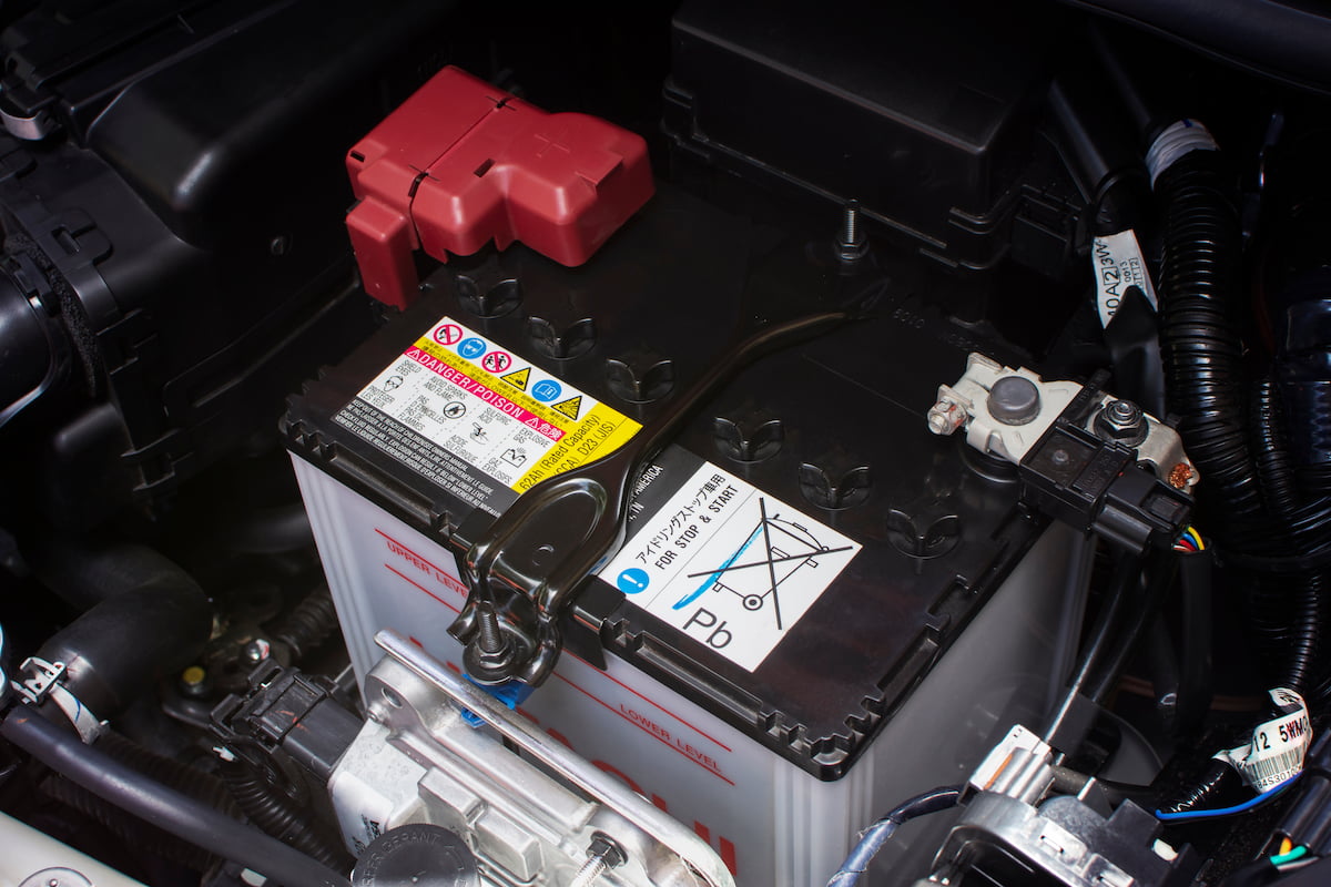 A clean car battery installed in engine bay