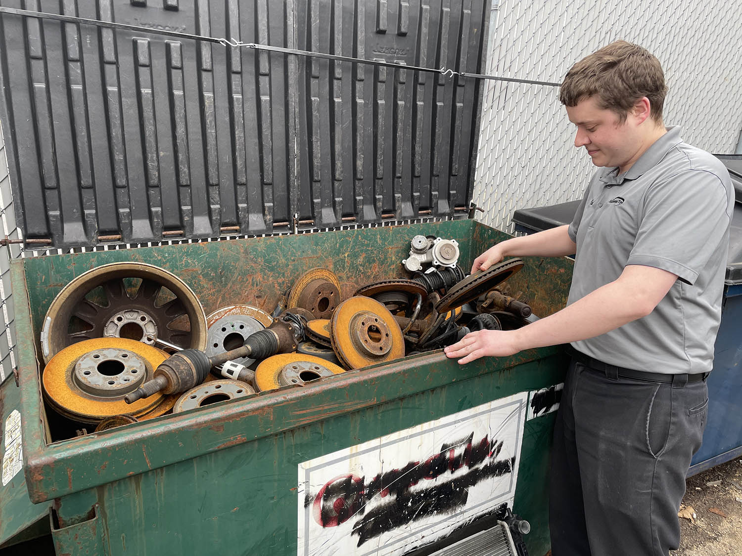 matthews tire employee recycling old auto parts
