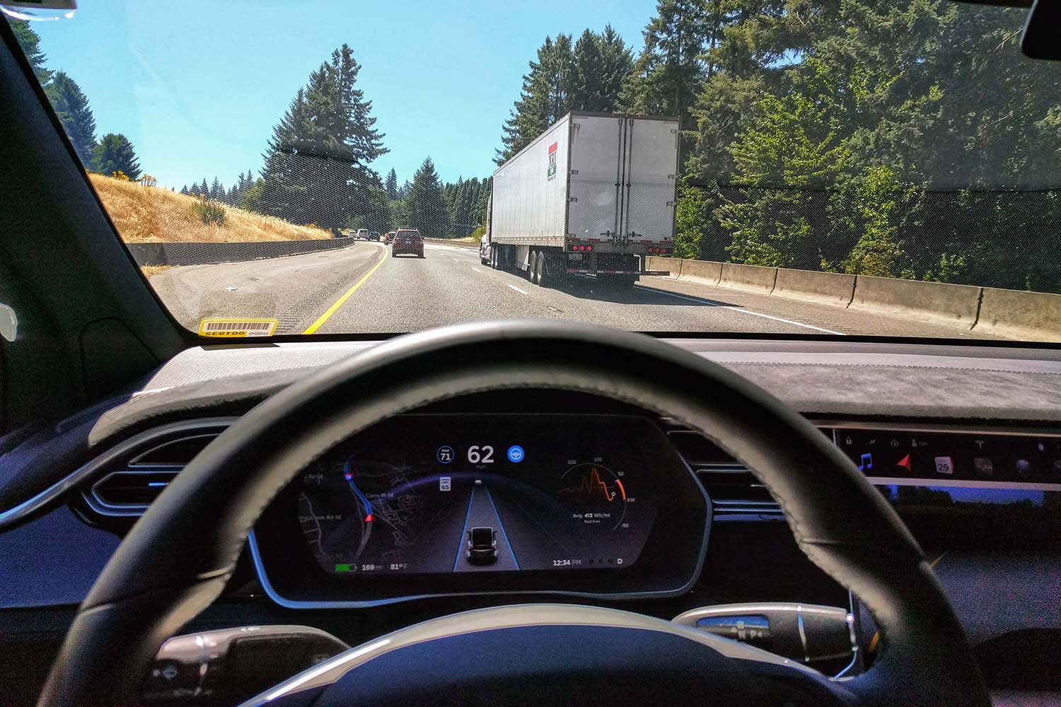 Car driving down road with lane assist display on dashboard