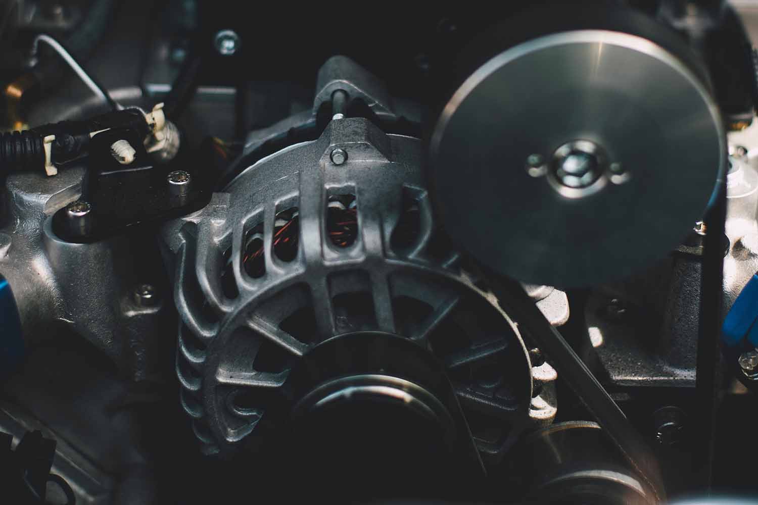 Close up look of an alternator inside an engine bay