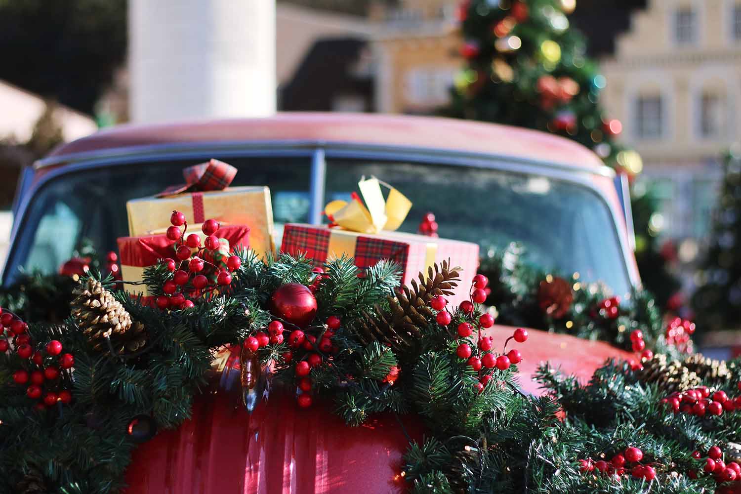 Christmas gifts on top of a classic car
