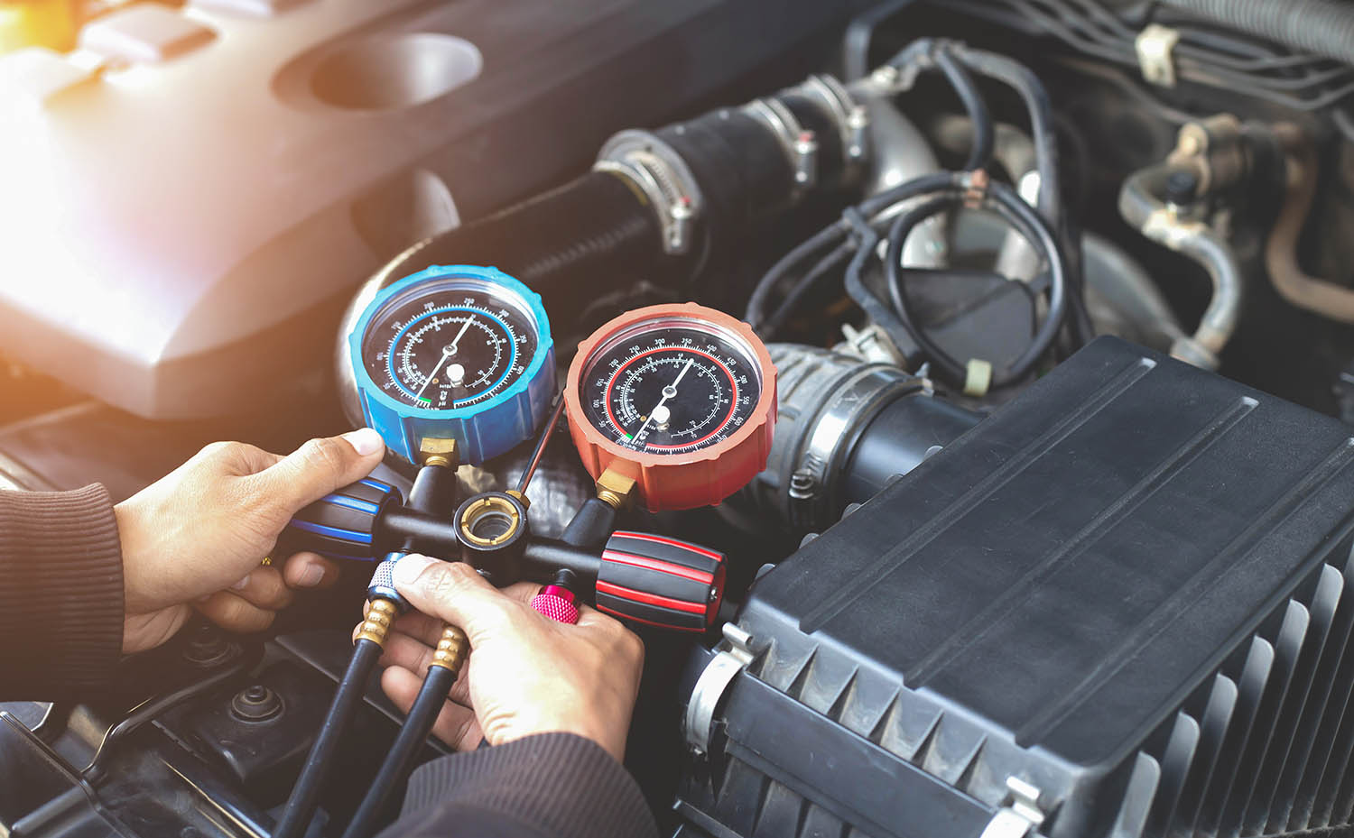 Technician checking the air conditioning system of a vehicle