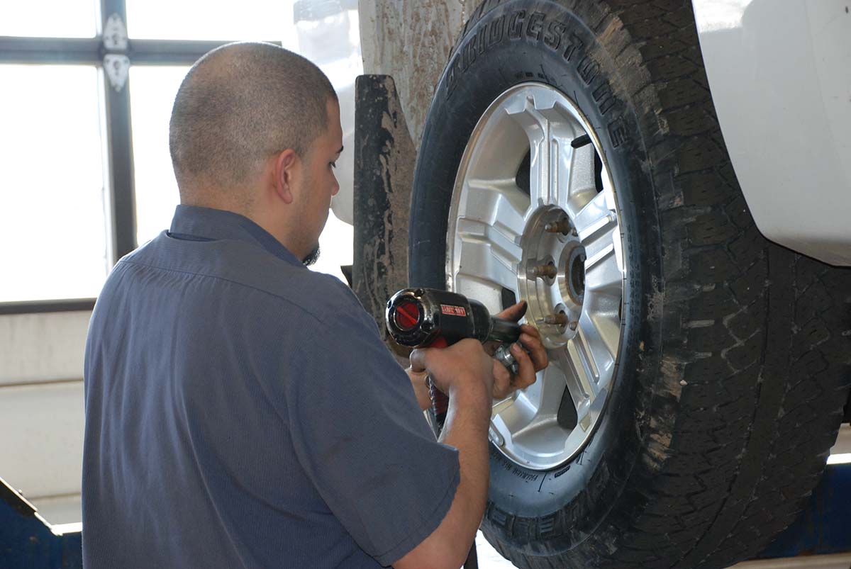 brand new windshield being installed on a car in garage