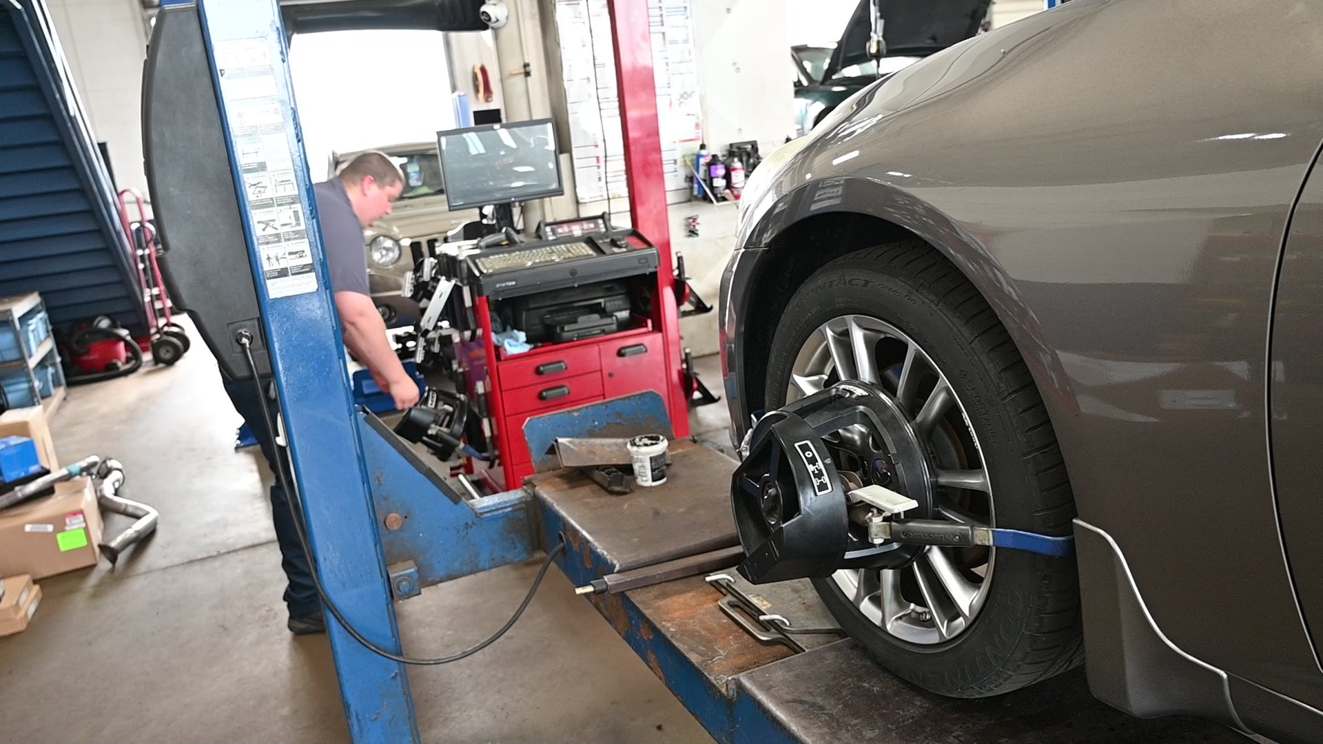 Vehicle on lift with alignment sensors and computer calibration setup at Matthews Tire in Appleton, WI.