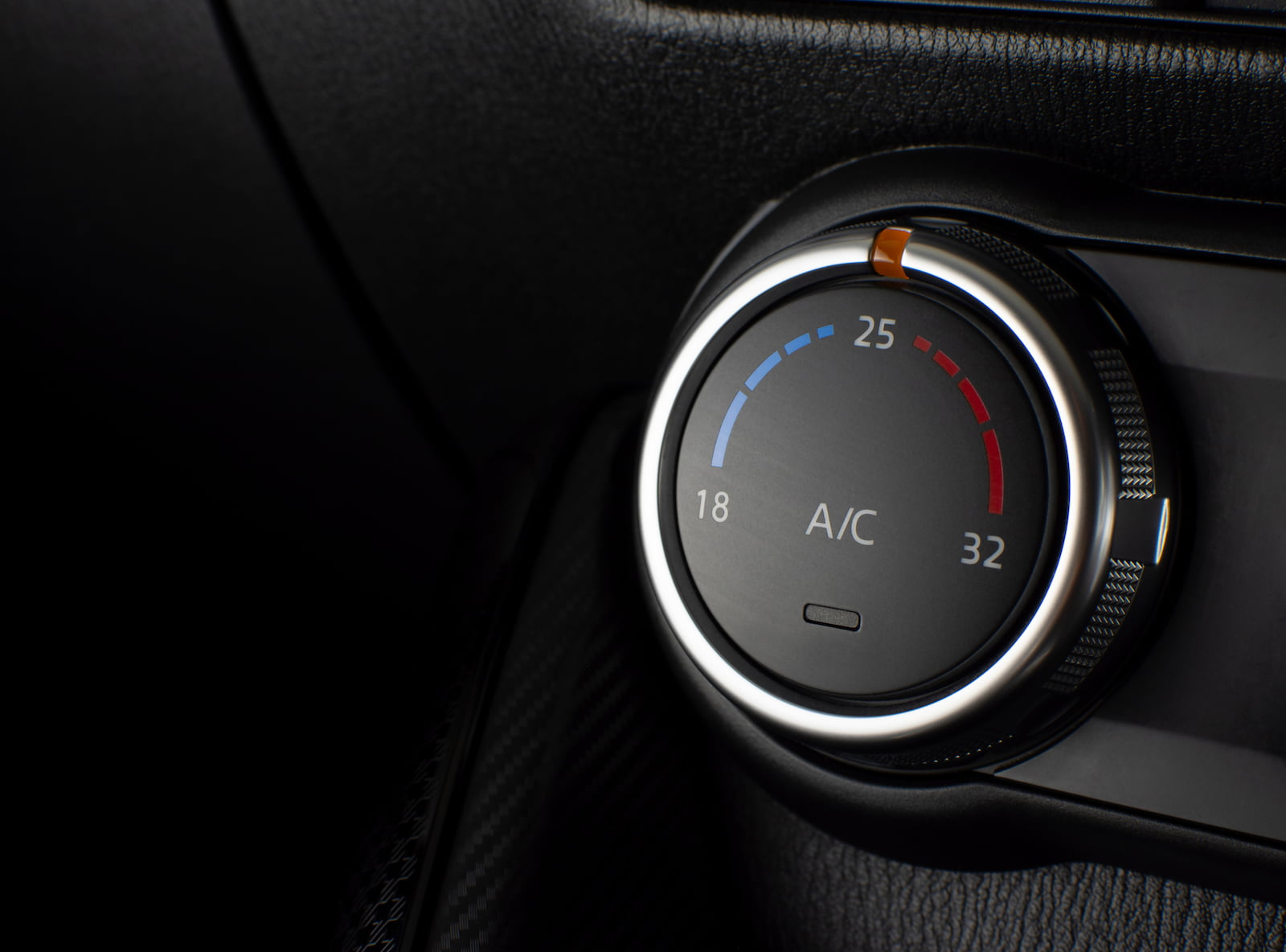 Close-up of a car AC temperature control dial set to 25°C in Appleton, WI.