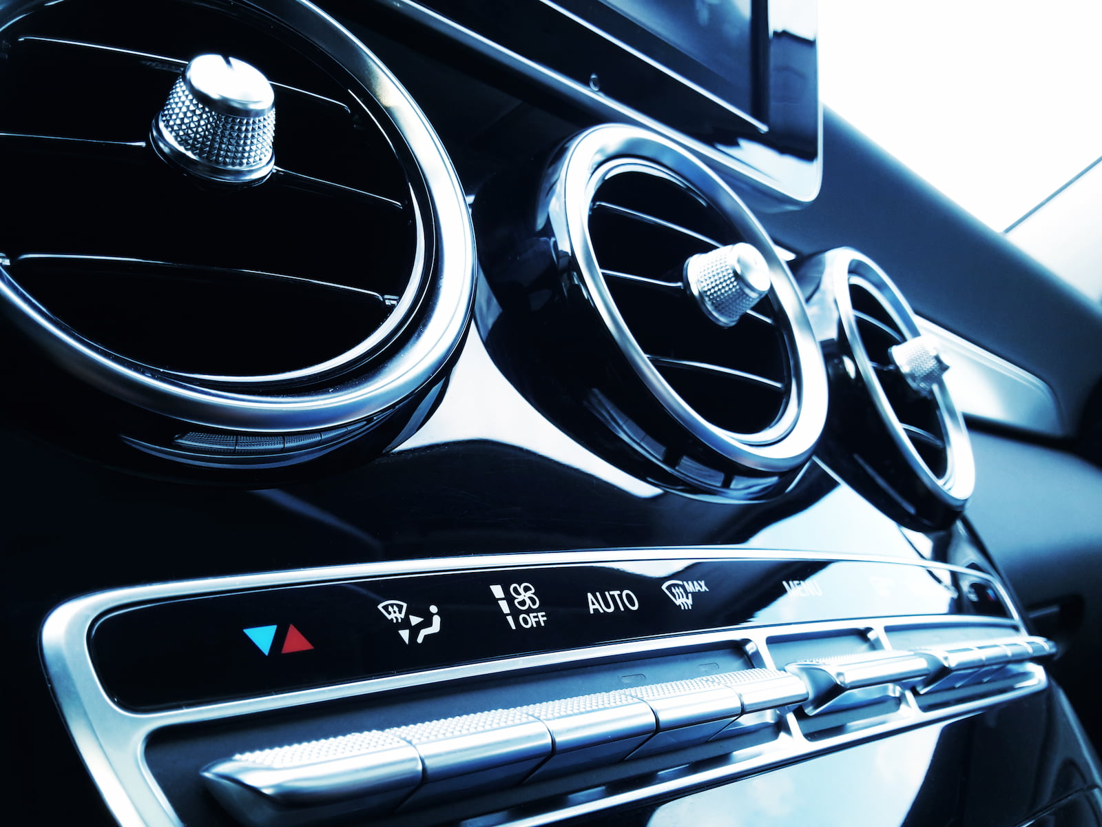 Close-up of luxury car air vents and climate control panel in Green Bay, WI.