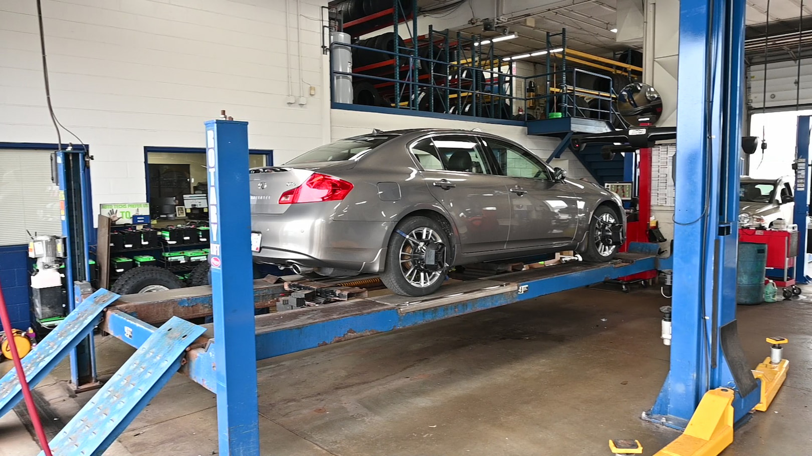 Sedan on alignment rack at Matthews Tire during wheel alignment in Green Bay, WI.