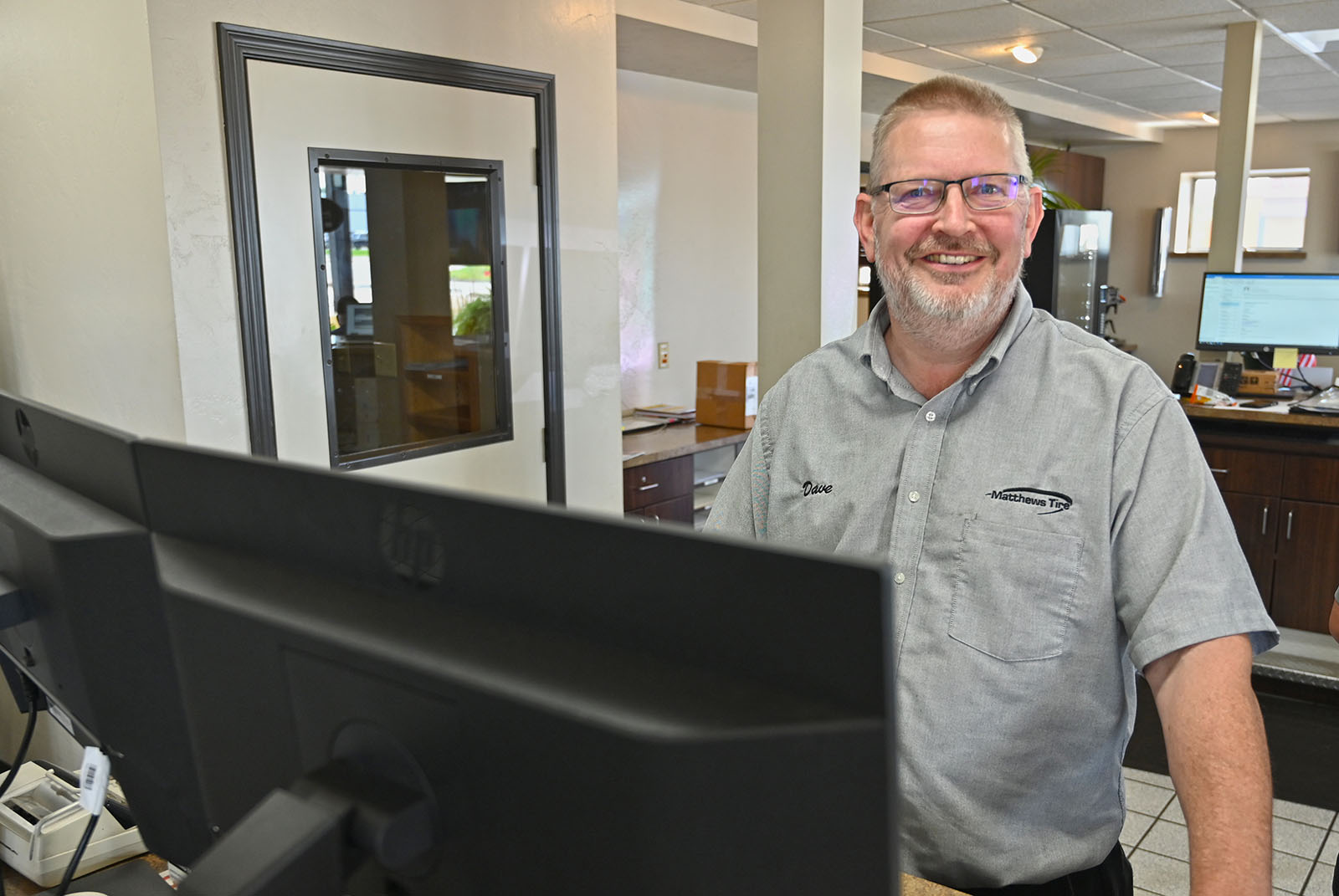 Dave Flunker working at the front desk of the Appleton West location