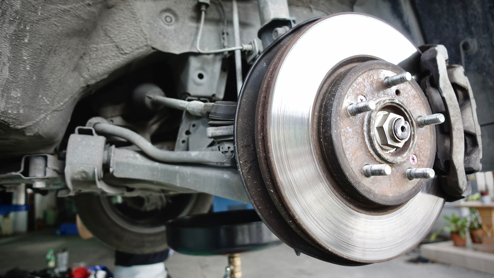 Close-up of front disc brake and caliper assembly during brake repair in Green Bay, WI.