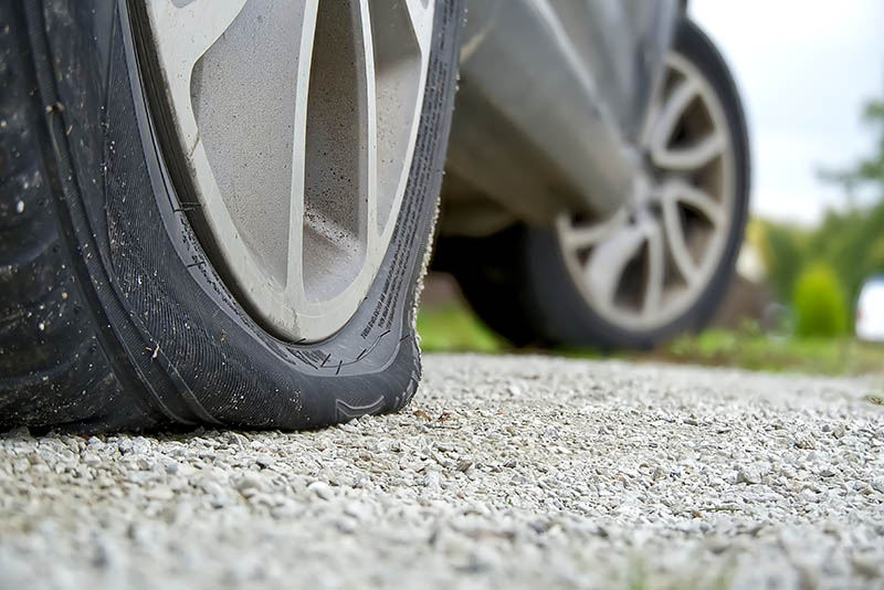 Person torquing down lug nuts while performing a tire rotation service