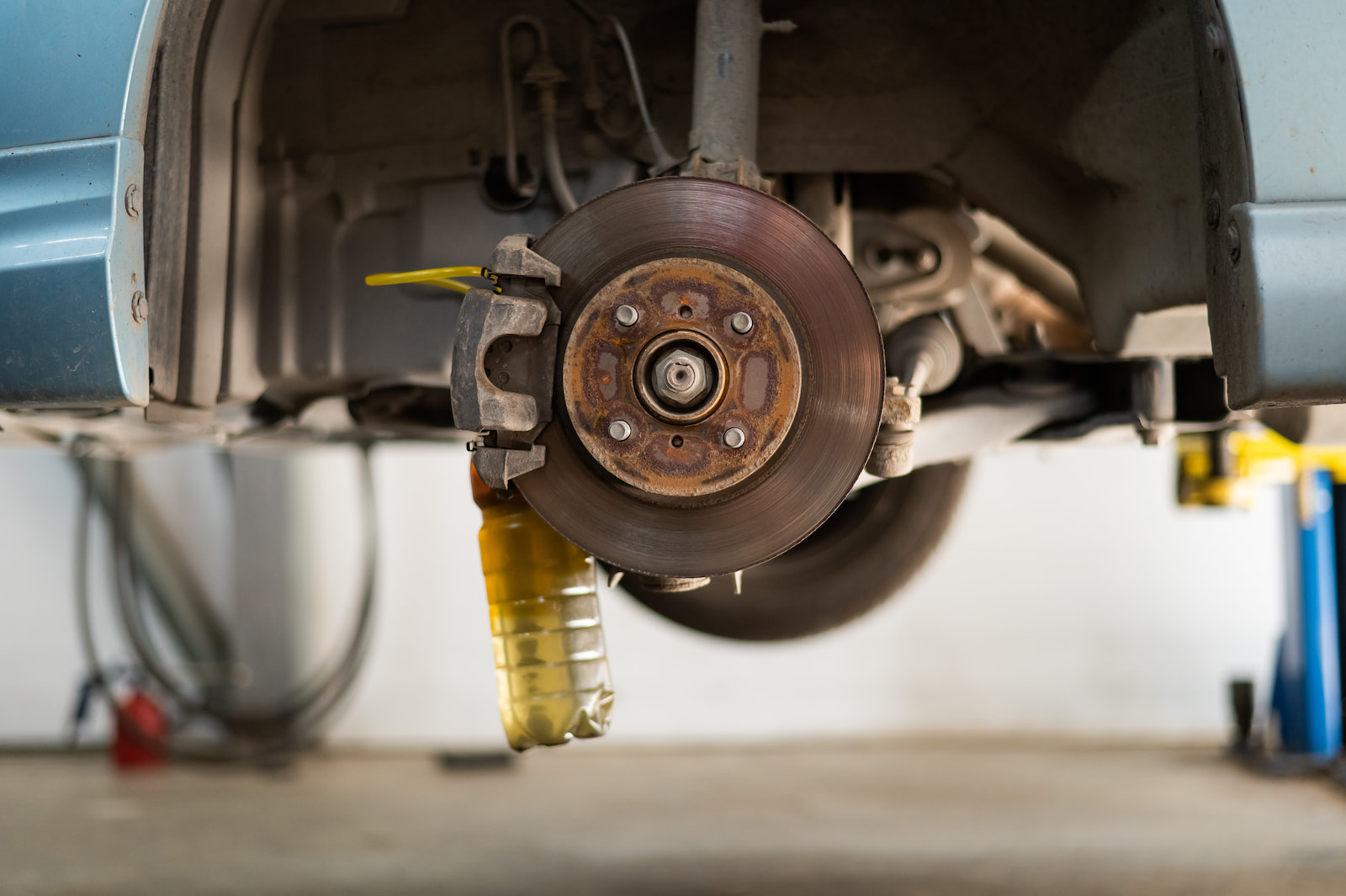 Front disc brake and caliper assembly exposed during vehicle inspection in Fond du Lac, WI.