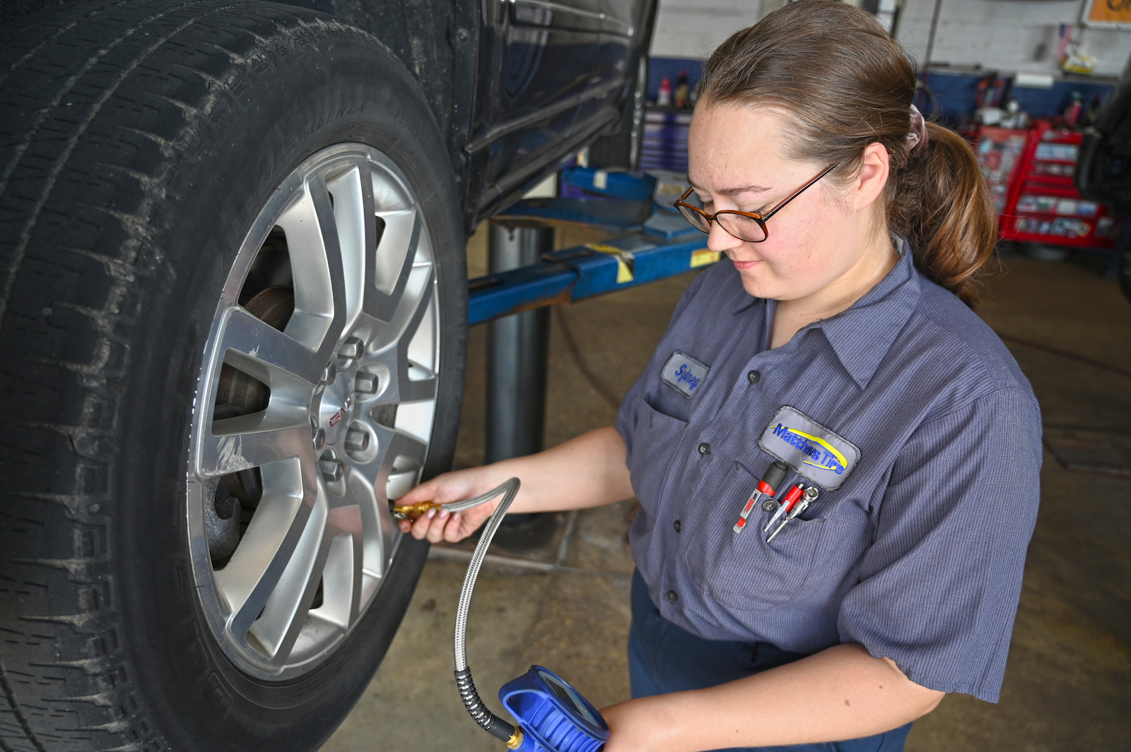 Technician checking tire pressure