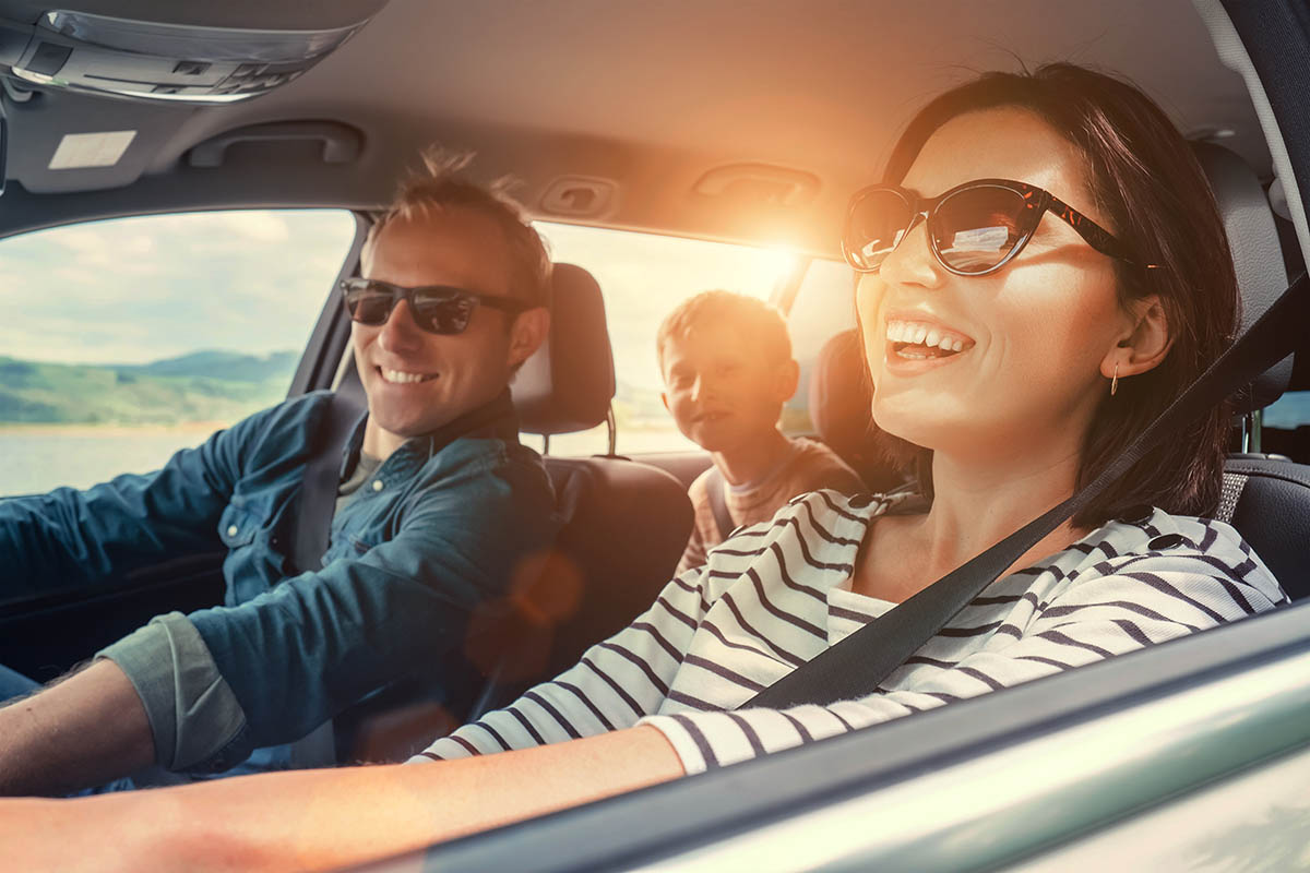 Happy family driving in a car together