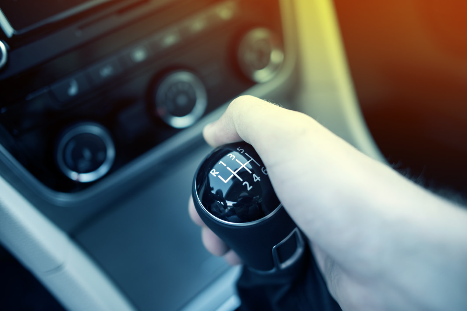 Driver hand on manual gear shift during transmission check in Fond du Lac, WI.