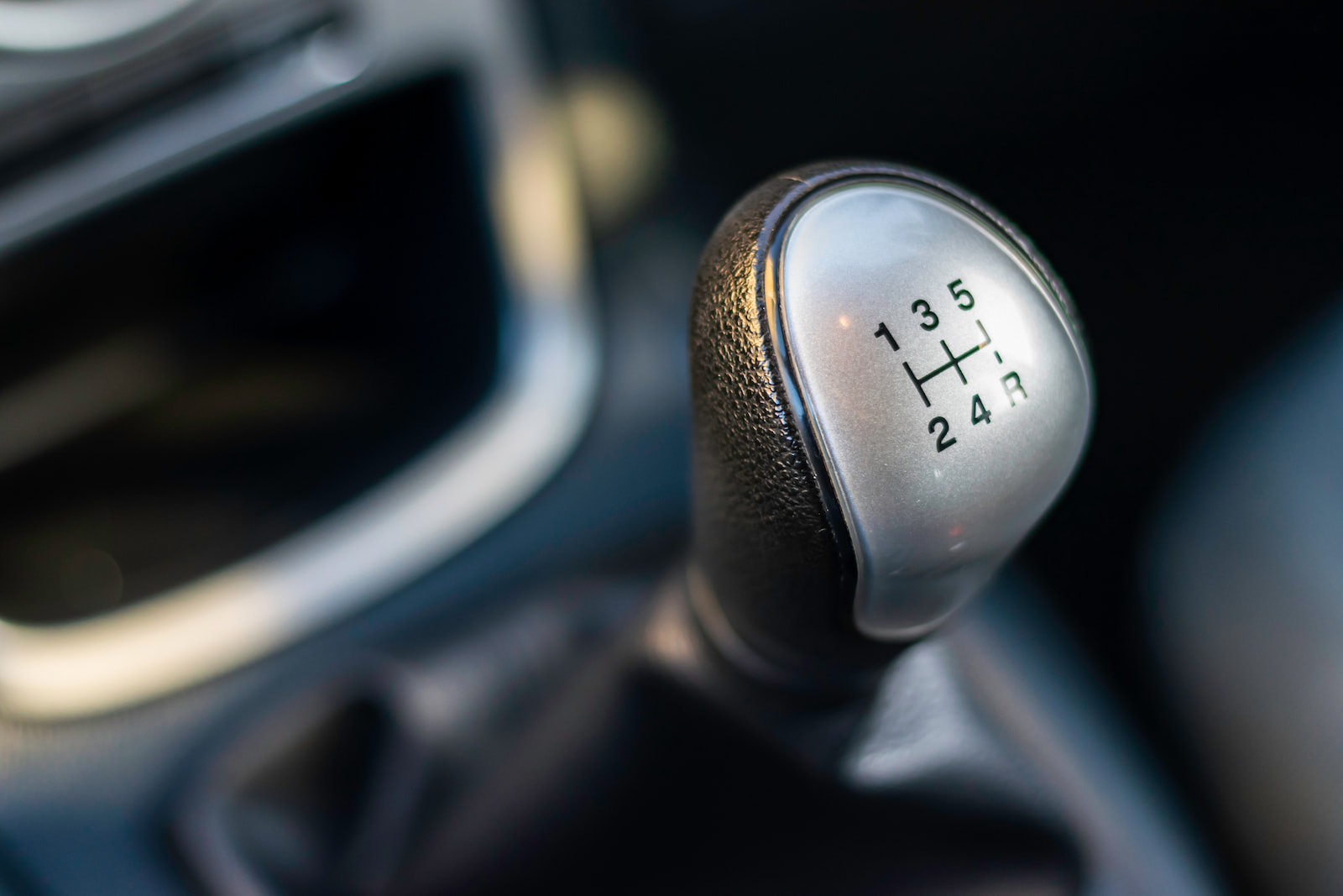 Close-up of manual transmission shifter in vehicle serviced in Green Bay, WI.