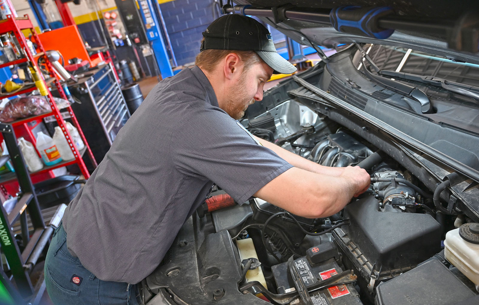 Matthews Tire automotive technician working on an engine