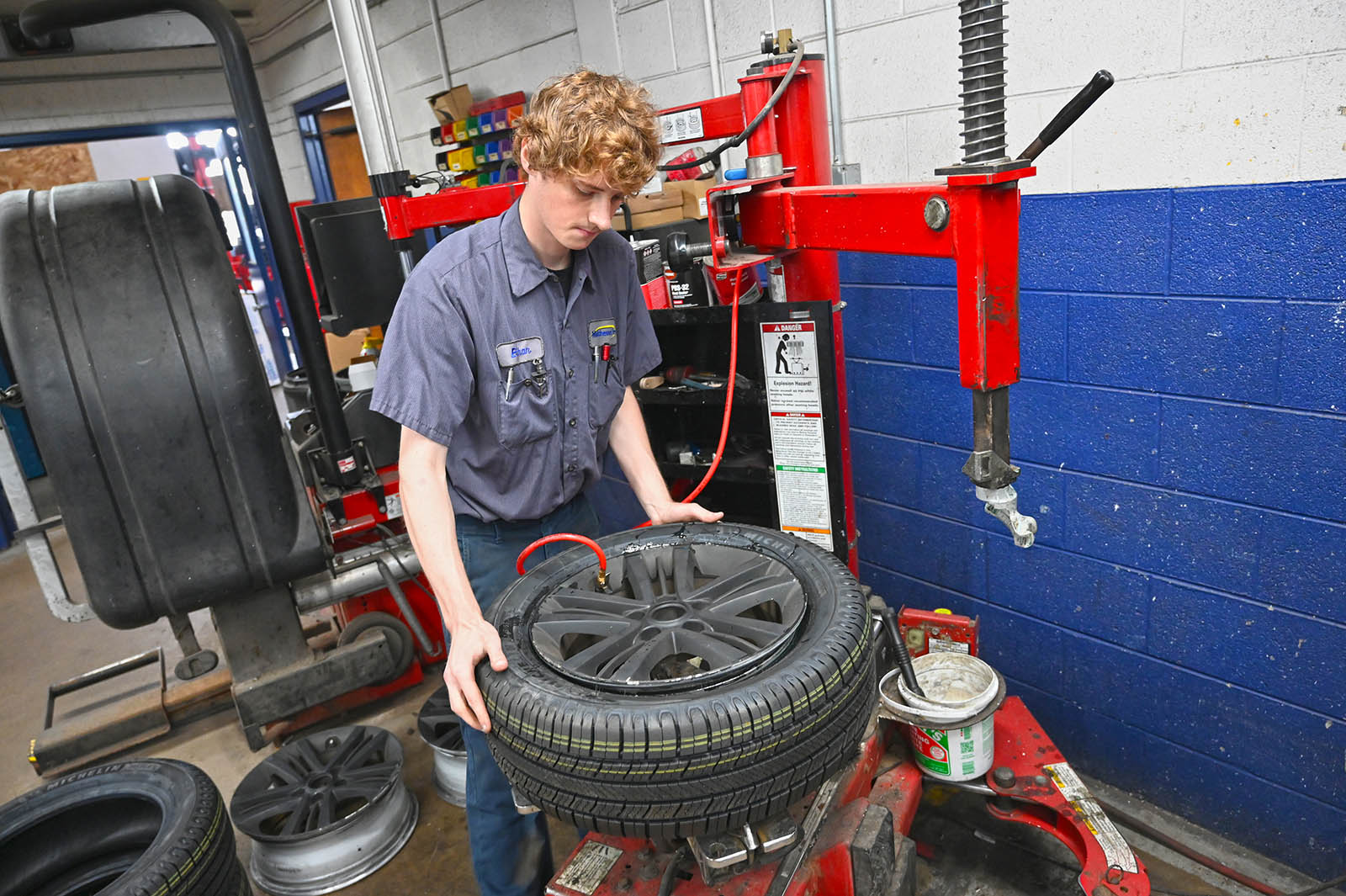 Matthews Tire technician mounting tire