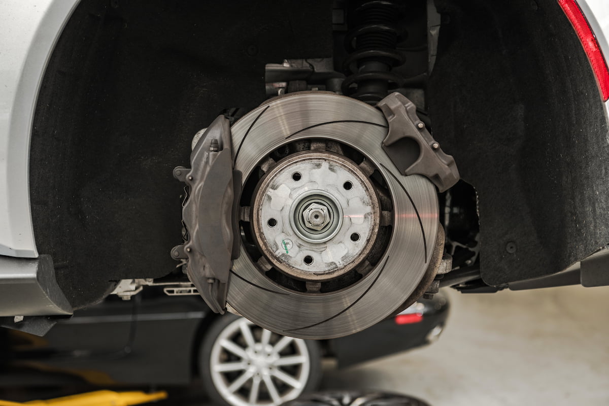 new brake pads and rotors on vehicle raised on lift