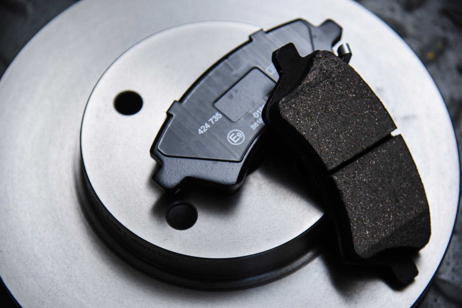 new brake pads and rotors sitting on table