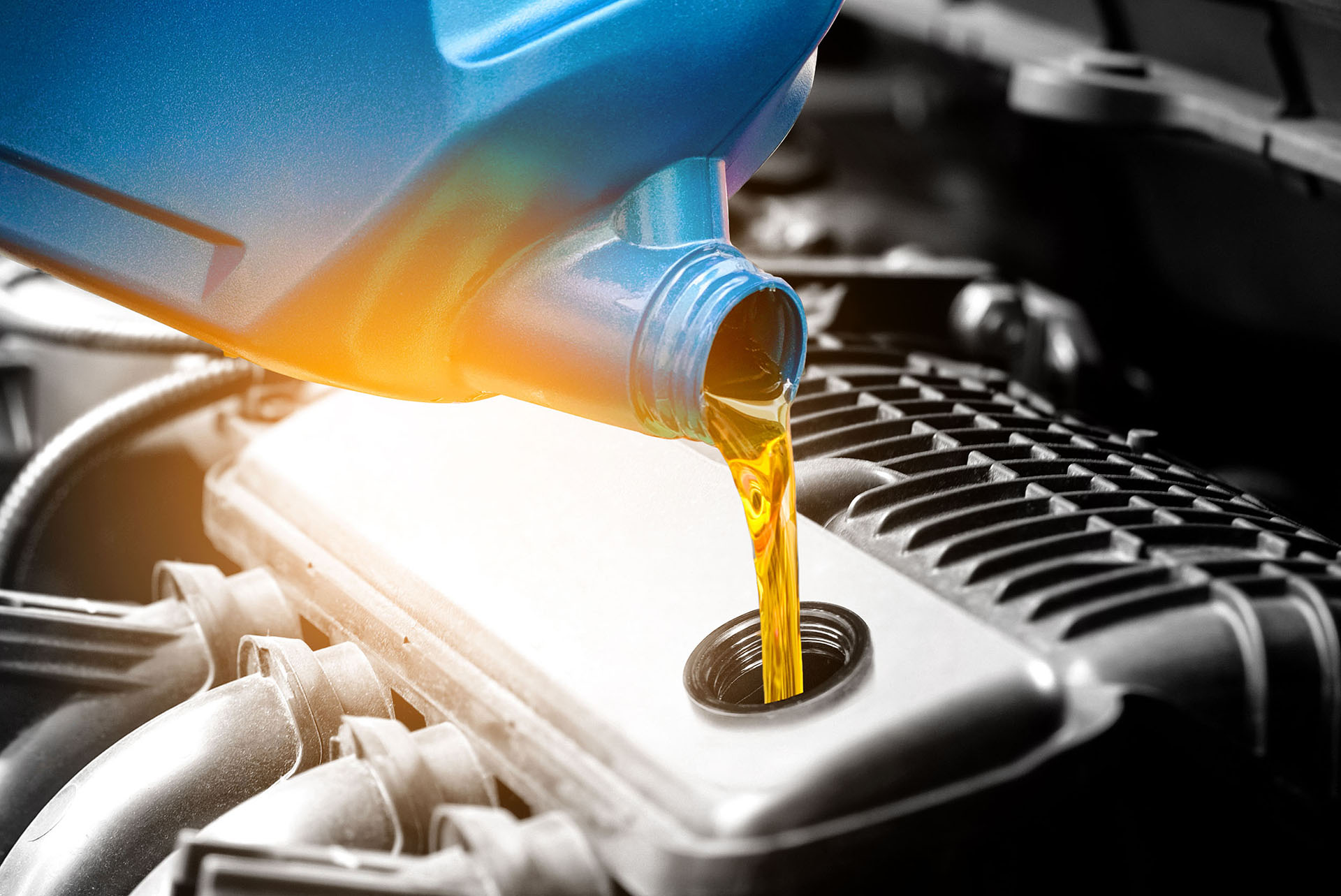 Oil being poured into engine during an oil change service