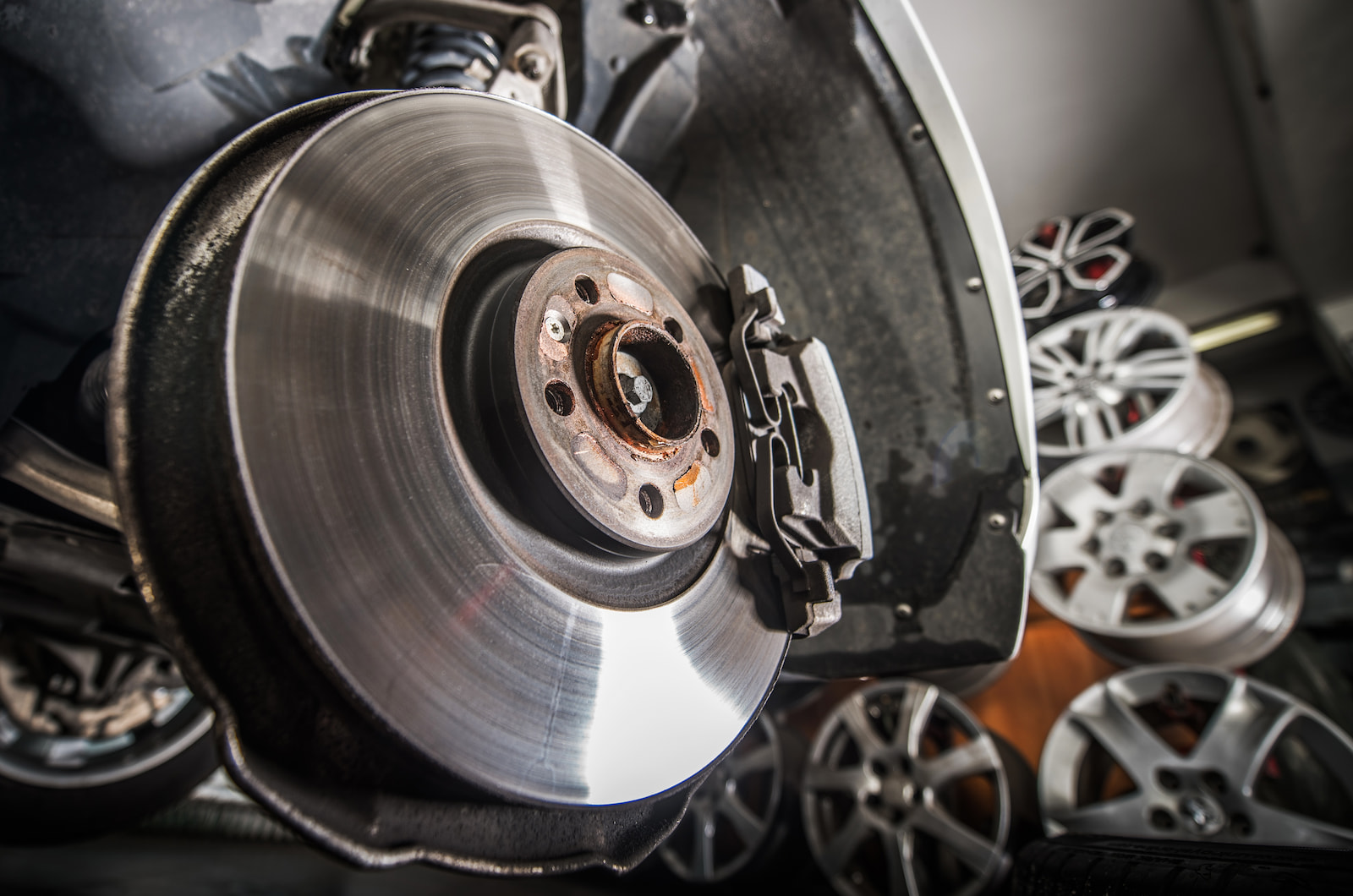 Close-up of clean disc brake and caliper assembly on vehicle in Menasha, WI auto shop.