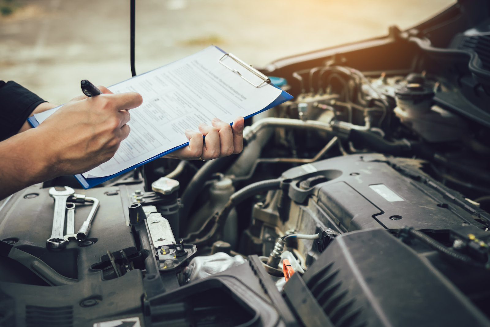 Technician completing a multi-point vehicle inspection during an oil change in Fond du Lac, WI.