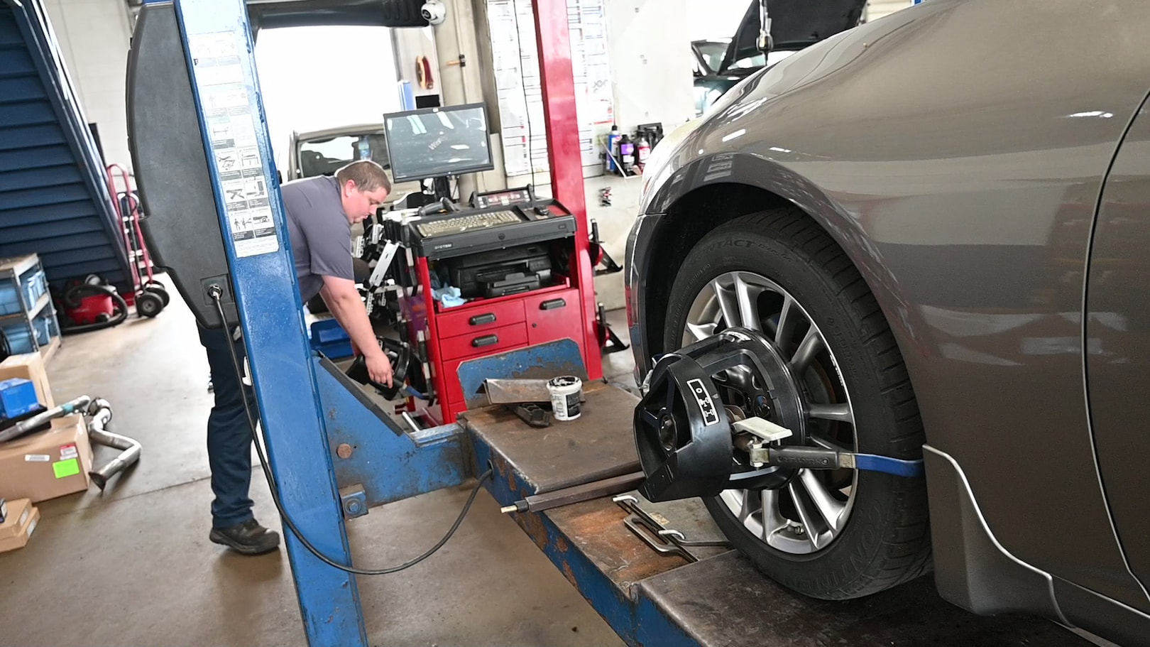 Matthews Tire technician calibrating wheel alignment system in Fond du Lac, WI.