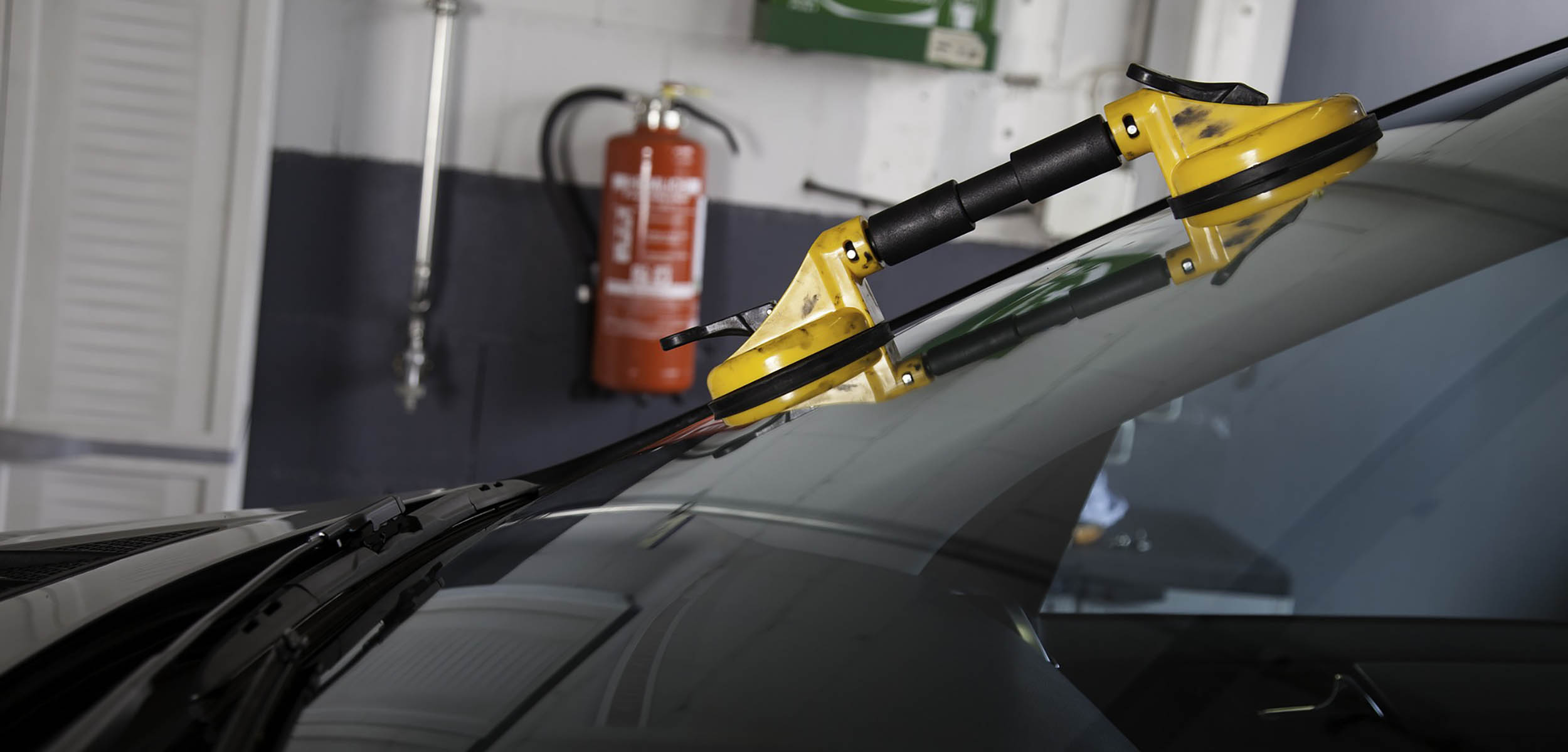 A new windshield being installed on vehicle