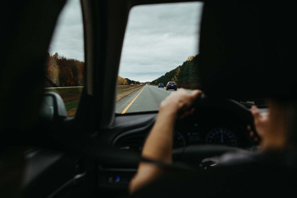 person-driving-in-left-lane-of-two-lane-highway