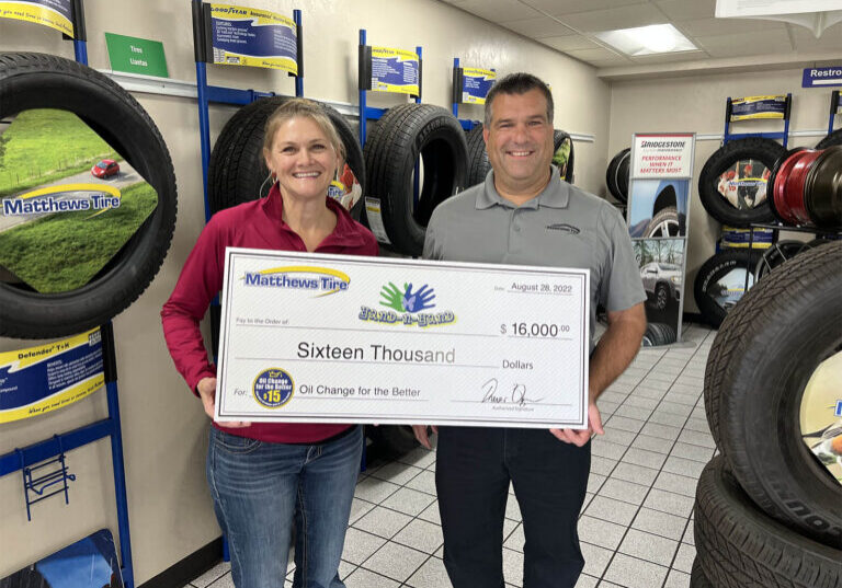 matthews-tire-president-trevor-reznor-presents-check-to-hand-n-hand