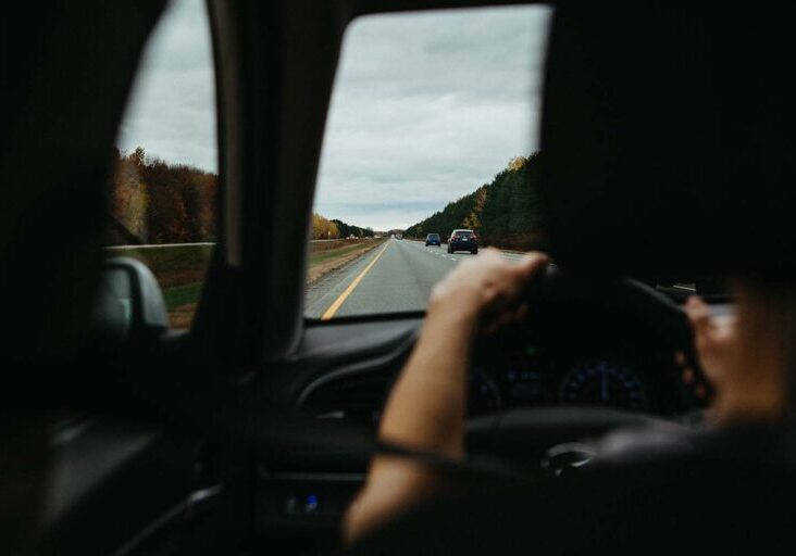 person-driving-in-left-lane-of-two-lane-highway